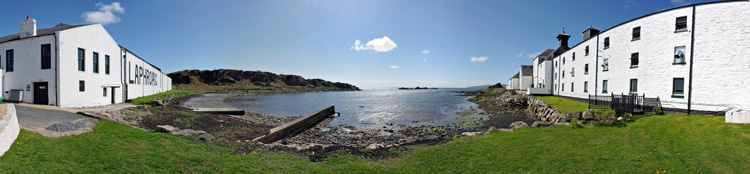 Picture of a panoramic view over a sea loch flanked by a distillery (Laphroaig distillery at Loch Laphroaig, Isle of Islay)