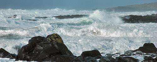 Picture of wild seas with white waves and foam on a rocky shore