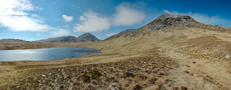 Picture of a panoramic view over a loch (lake) and three mountains (the Paps of Jura)