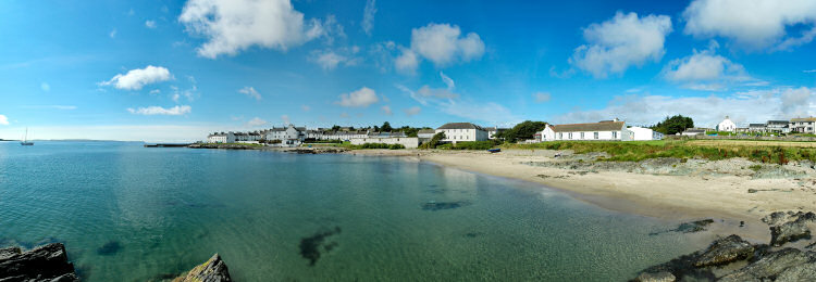 Picture of a panoramic view over a beach and a coastal village with whitewashed houses
