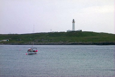Picture of the view from Portnahaven to Orsay with the lighthouse
