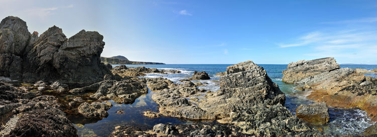 Picture of a panoramic view over a rocky shore with steep cliffs