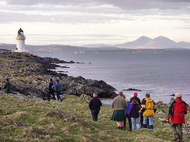 Picture of a group of walkers approaching a lighthouse